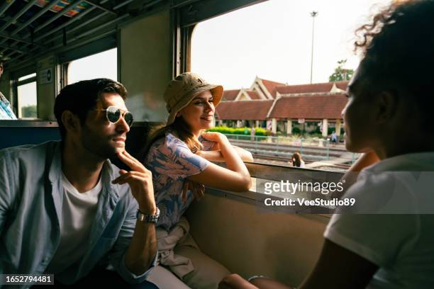 group of diversity people friends travel in thailand on local train. - travel budget stock pictures, royalty-free photos & images