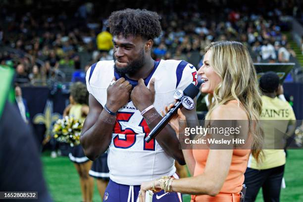 Will Anderson of the Houston Texans is interviewed on the sidelines during the preseason game against the New Orleans Saints by Erin Andrews at...