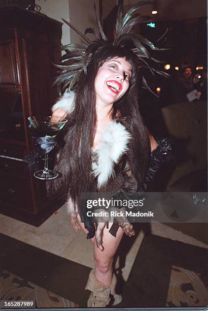 While son Evan Shane is entertained by a costumed partygoer, Paul Stanley and wife Pamela Bowen enter the Courtyard Cafe for the final wrap party of...