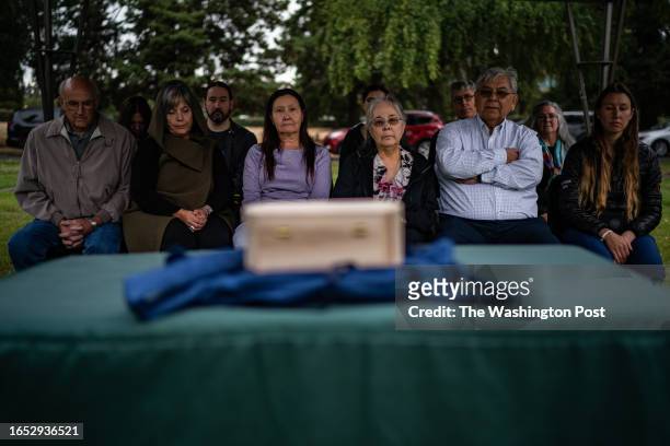 Family members and friends of Mary Sara gather during a service to reunited Mary Sara's brain into her unmarked grave after it was returned from the...