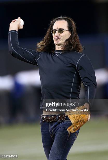 Rush singer Geddy Lee throws out the first pitch before the Cleveland Indians MLB game against the Toronto Blue Jays during Opening Day on April 2,...