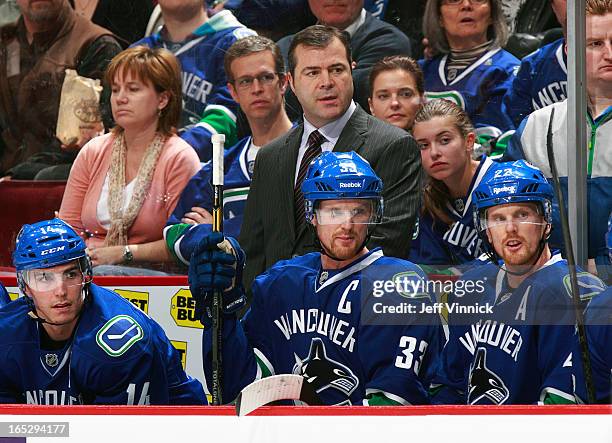 Head coach Alain Vigneault of the Vancouver Canucks looks on from the bench during an NHL game against the St. Louis Blues at Rogers Arena March 19,...