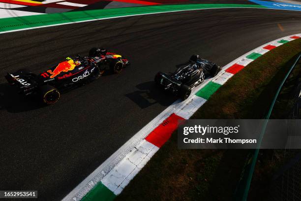 Sergio Perez of Mexico driving the Oracle Red Bull Racing RB19 and George Russell of Great Britain driving the Mercedes AMG Petronas F1 Team W14 on...