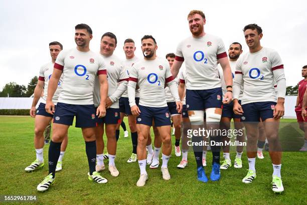 The England players wait for Owen Farrell of England to walk onto the pitch on his own as a joke during a training session at Stade Ferdinand Petit...
