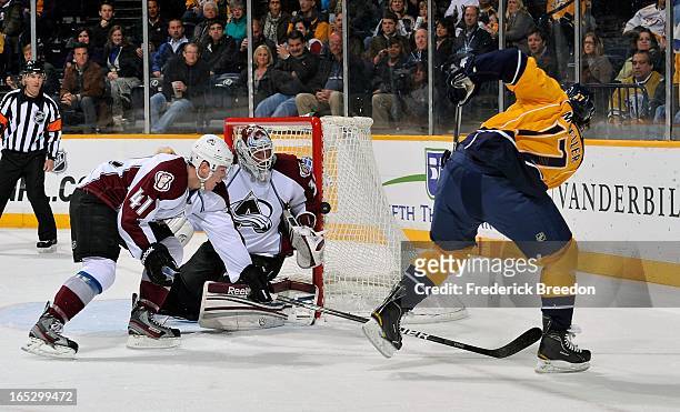 Shot by Chris Mueller of the Nashville Predators hits the post in front of goalie Jean-Sebastien Giguere and Tyson Barrie of the Colorado Avalanche...
