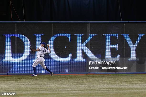 Dickey of the Toronto Blue Jays warms up in left field as he is recognized for his Cy Young Award from 2012 before MLB game action on Opening Day...