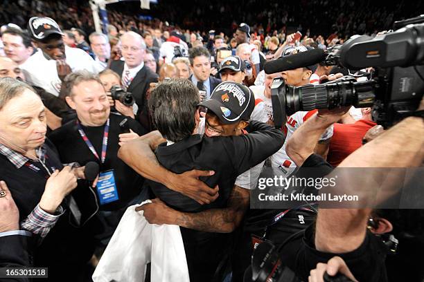 Russ Smith and head coach Rick Pitino celebrate winning in the finals of the Big East Basketball Tournament against the Louisville Cardinals at...