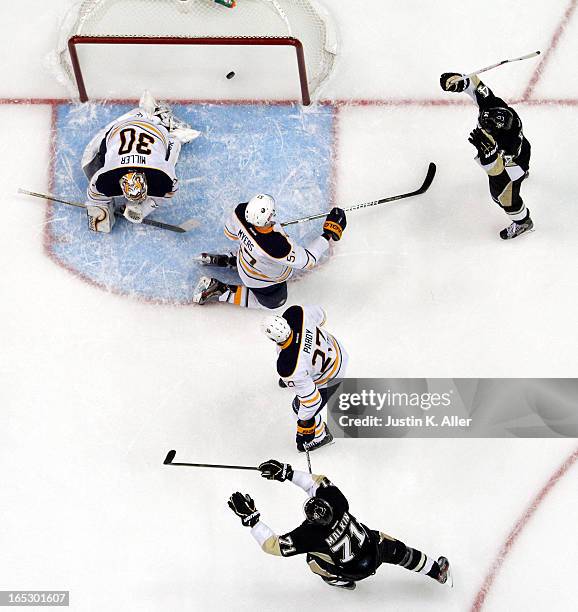 Chris Kunitz and Evgeni Malkin of the Pittsburgh Penguins celebrates Jarome Iginla's first goal as a Penguin against the Buffalo Sabres during the...