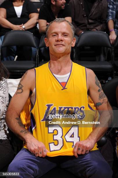 Recording artist Flea of the Red Hot Chili Peppers poses for a photograph while wearing the jersey of former Lakers player Shaquille O'Neal at...