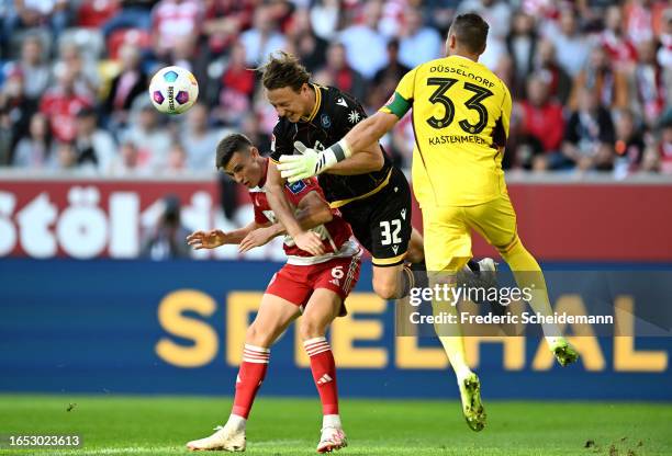 Robin Bormuth of Karlsruher SC battles for possession with Yannik Engelhardt and Florian Kastenmeier of Fortuna Düsseldorf during the Second...