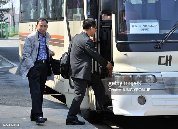 South Korean workers take a shuttle bus going to Seoul at the inter-Korean transit office after being refused access to Kaesong joint industrial park...