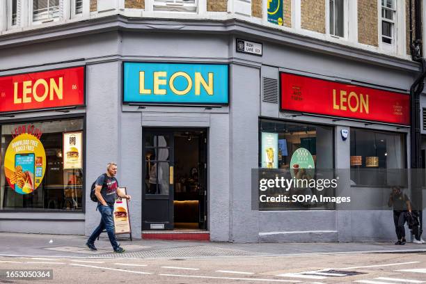 Man walks past a LEON restaurant in London.