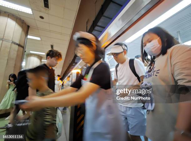 Passengers get on and off the subway at Jianguomen subway station in Beijing, China, September 7, 2023.