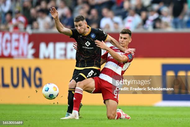Leon Jensen of Karlsruher SC battles for possession with Yannik Engelhardt of Fortuna Düsseldorf during the Second Bundesliga match between Fortuna...