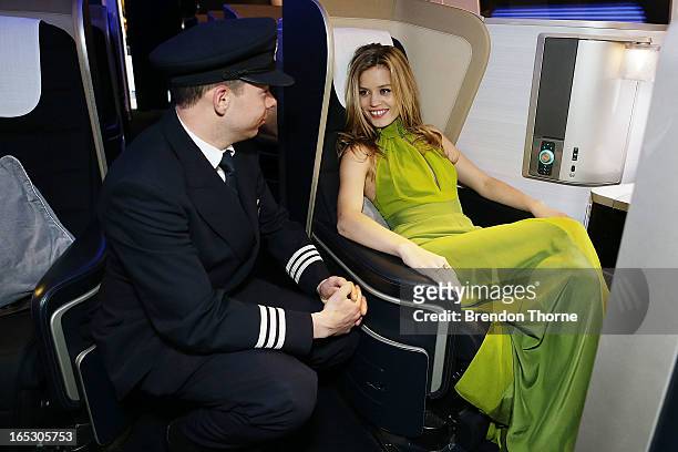 Georgia May Jagger wearing Tech Empire dress by PPQ speaks with a British Airways pilot in first class on April 3, 2013 in Sydney, Australia....
