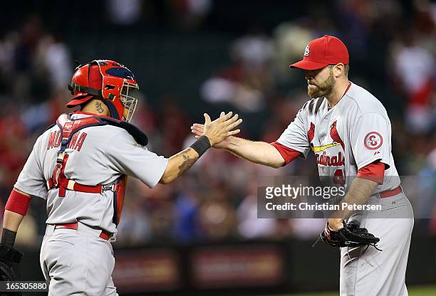 Relief pitcher Mitchell Boggs of the St. Louis Cardinals celebrates with catcher Yadier Molina after defeating the Arizona Diamondbacks 6-1 in the...