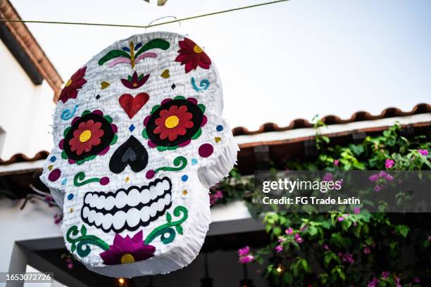 sugar skull piñata for day of the dead - piñata stock pictures, royalty-free photos & images