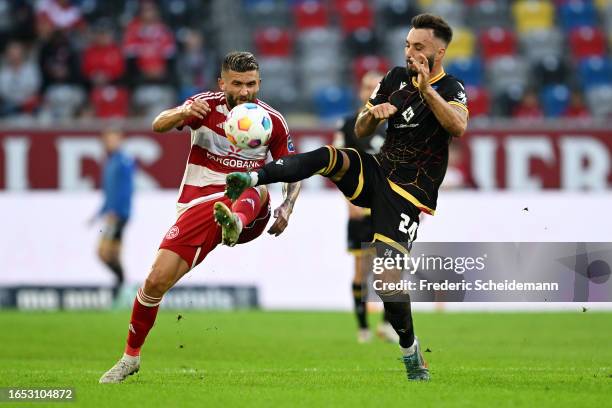 Fabian Schleusener of Karlsruher SC battles for possession with Nicolas Gavory of Fortuna Düsseldorf during the Second Bundesliga match between...