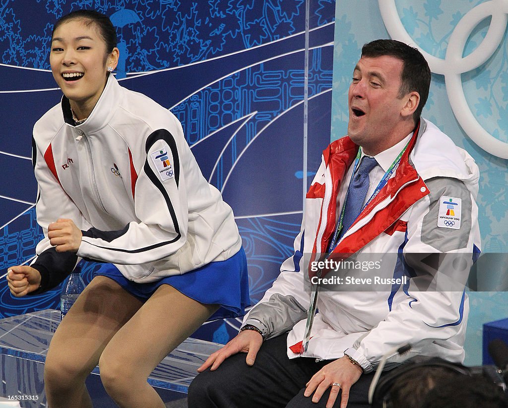 February 25, 2010 Gold medalist South Korea's Kim Yu-Na and coach Brian Orser react to her score dur