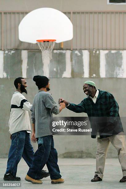 After sinking five consecutive buckets, Alimamy Bangura, is congratulated by teammates. Alimamy Bangura is the director of MENTORS, Muslim...