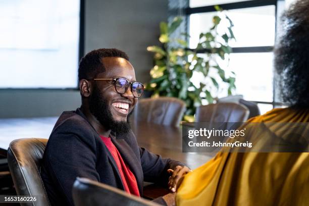 relaxed moment during business meeting in nairobi office - kenya business stock pictures, royalty-free photos & images