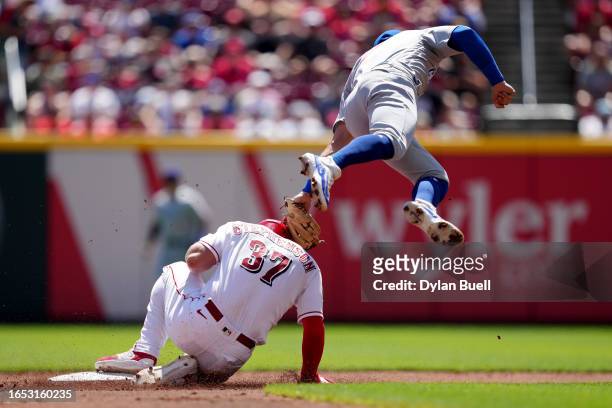 Tyler Stephenson of the Cincinnati Reds advances to second base on a wild pitch past Nico Hoerner of the Chicago Cubs in the second inning during...