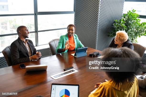 nairobi business team talking and smiling during meeting - kenya business stock pictures, royalty-free photos & images