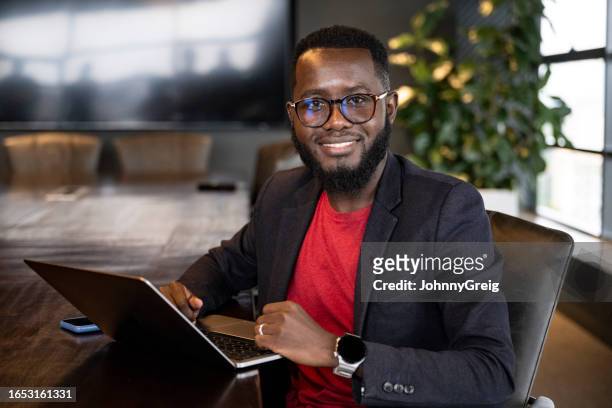 portrait of bearded african businessman with laptop - kenya business stock pictures, royalty-free photos & images
