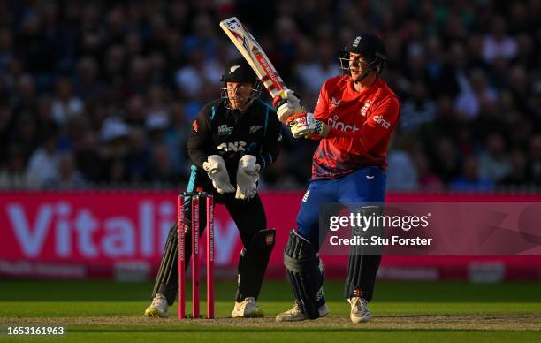 England batsman Harry Brook reverse sweeps a ball to the boundary watched by New Zealand wicketkeeper Tim Seifert during the 2nd Vitality T20I match...