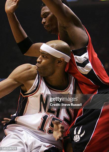 Vince Carter @#15 drives into Chris Bosh @#4 as the Toronto Raptors visit the New Jersey Nets in Game Three at the Continental Airlines Arena in East...