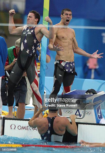 August 10 Michael Phelps, right and the team's second swimmer celebrate their come from behind victory in the 4x100 m Freestyle relay by less than a...