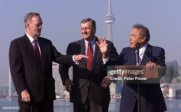 Images of Prime Minister Jean Chretien, Premier Mike Harris, and Toronto Mayor Mel Lastman, arriving by boat to the Docks, where the announcement was...