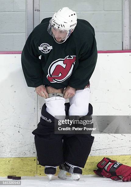 Vs DEVILS-Petr Sykora, of the New Jersey Devils, has his pants down around his ankels, as he adjusts his knee brace, and pulls his sock up during the...