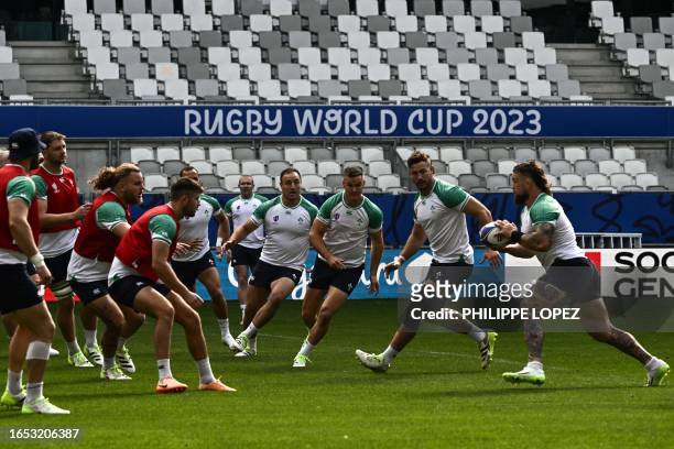 Ireland's prop Andrew Porter runs with the ball during a 'Captain's Run' training session at The Matmut stadium in Bordeaux, southwestern France, on...