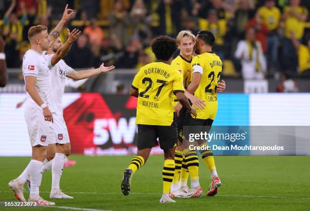 Julian Brandt of Borussia Dortmund celebrates with team mates after scoring their sides first goal during the Bundesliga match between Borussia...