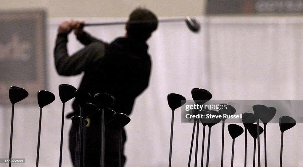 DIGITAL IMAGE----Fueled by the warm weather, golfers took their swings at one of two huge driving ra