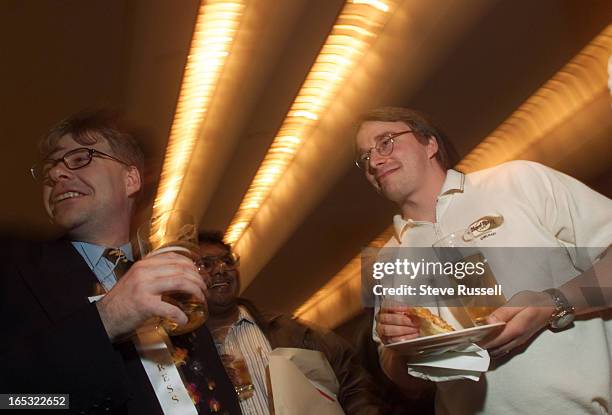 Linus Torvalds, far right, creator of Linux open-source software system, a competitor to Windows hosts a pizza and beer reception in Toronto, May 17,...