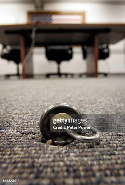 Padlock and steel ring are attached to the floor, and is used for securing detainees who attend the Administrative Review Boards hearings at GTMO....