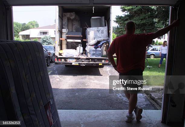 Moving day is the day Premier Mike Harris testifies at the Walkerton Inquiry in Walkerton, Ontario, June 29, 2001. Kevin Hammell moves his family...