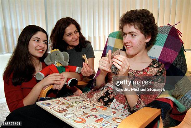 Nicole is spelled NIKOL. Georgia Markidou-in middle- with daughters Andrea -seated-curly short hair. And Nikol on left holding the Babar stuffed...