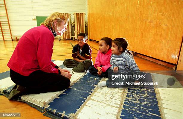 Connor Public School-principal Jill Worthy with Kindergarten students Justin Jackson-4.Cassandra Beckett-5 and Tharnigaa Manohara-5.they are sitting...
