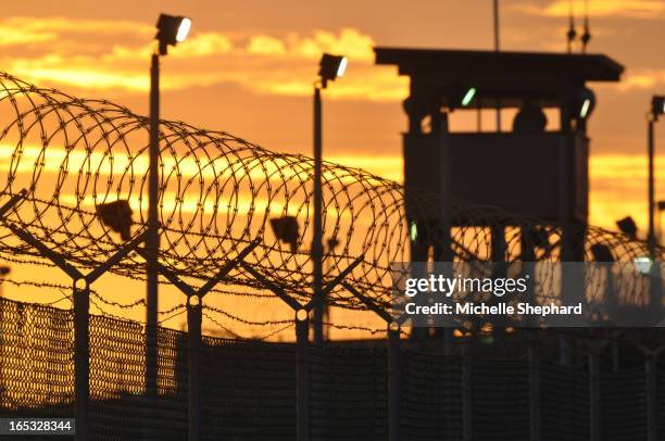 Guard watches over Camp Delta prison where Canadian Omar Khadr is detained Oct 24, 2010.