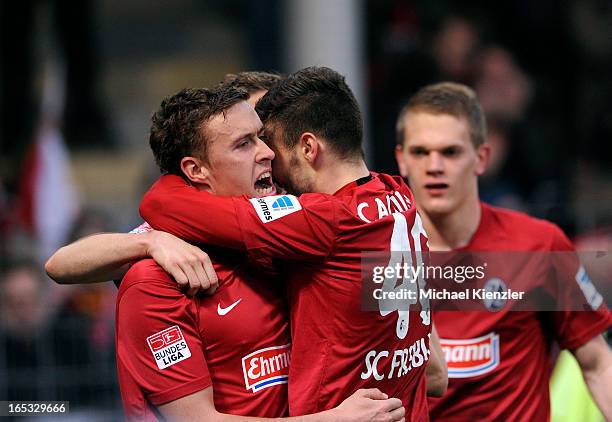 Max Kruse and Daniel Caligiuri of Freiburg celebrate the opening goal of Kruse during the Bundesliga match between SC Freiburg and VfL Borussia...