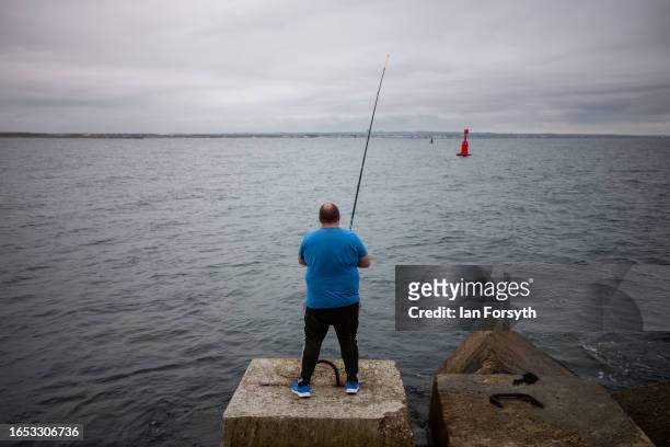 Fisherman fishes at South Gare breakwater on September 01, 2023 in Redcar, United Kingdom.