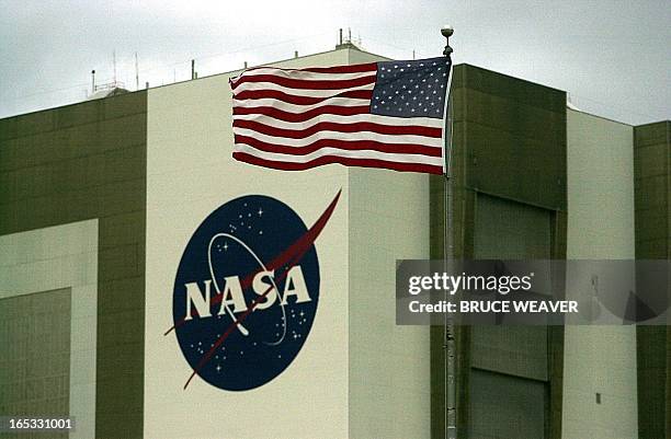 Flag stands out as winds over 20 mph buffet Kennedy Space Center 09 October 2000 to causing NASA managers delay the launch of the Space Shuttle...