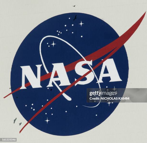 Vultures fly past a NASA logo on the Vehicle Assembly Building at Kennedy Space Center after a 24-hour delay of the launch of US space shuttle...