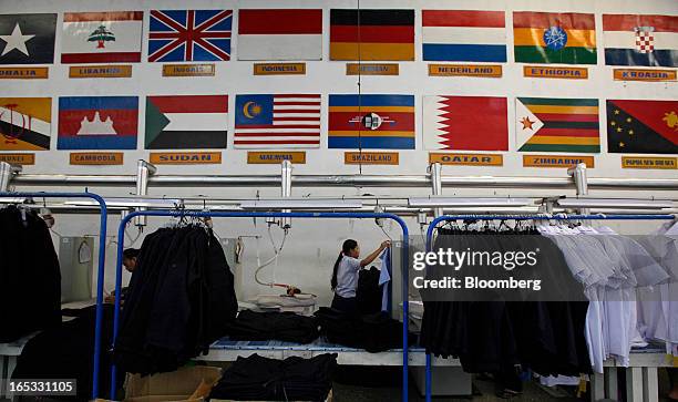 Finished shirts and jackets hang on racks as they await ironing in the garment area at a PT Sri Rejeki Isman factory in Sukoharjo, Java, Indonesia,...