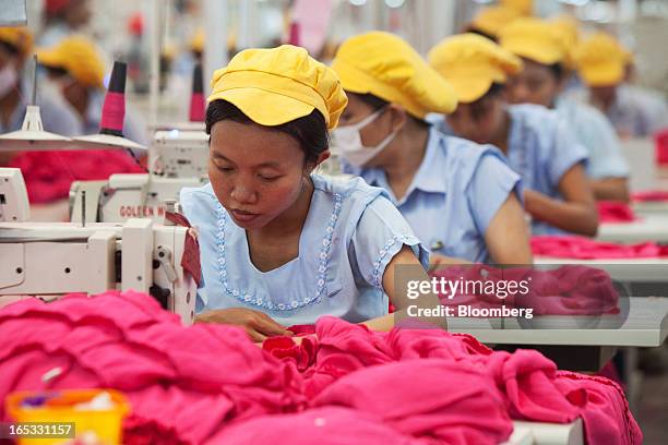 Workers sew women's dresses on the production line in the garment area at a PT Sri Rejeki Isman factory in Sukoharjo, Java, Indonesia, on Wednesday,...