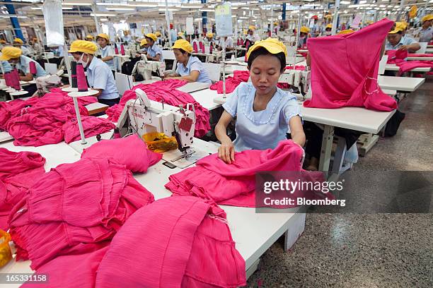 Workers sew women's dresses on the production line in the garment area at a PT Sri Rejeki Isman factory in Sukoharjo, Java, Indonesia, on Wednesday,...