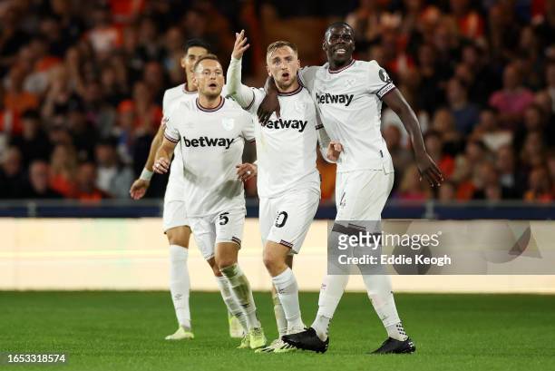 Jarrod Bowen of West Ham United celebrates with Kurt Zouma after scoring the team's first goal during the Premier League match between Luton Town and...